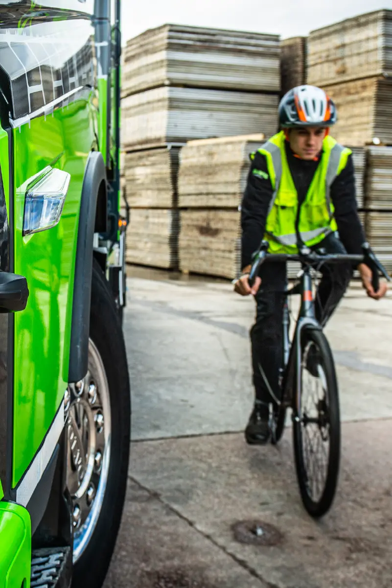 A cyclist in the blind spot of a truck.